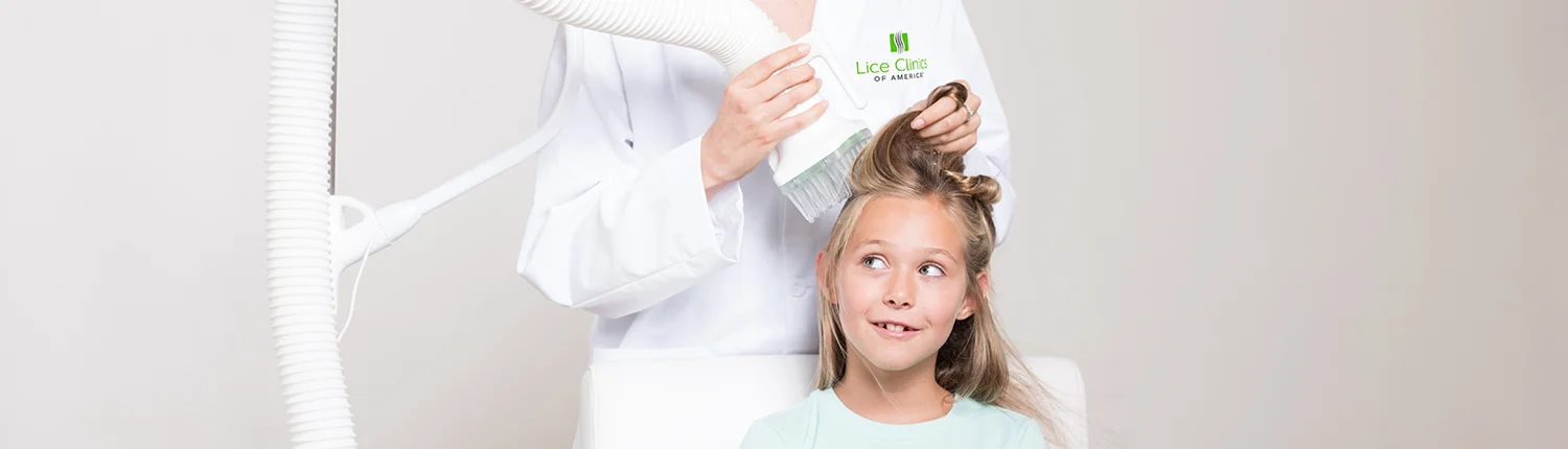 Child receiving professional lice treatment in houston