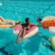 people floating in a pool on floaties